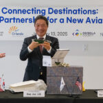 Lee Hag-jae, President & CEO of Incheon International Airport, displays a glass alligator during Monday's signing ceremony.